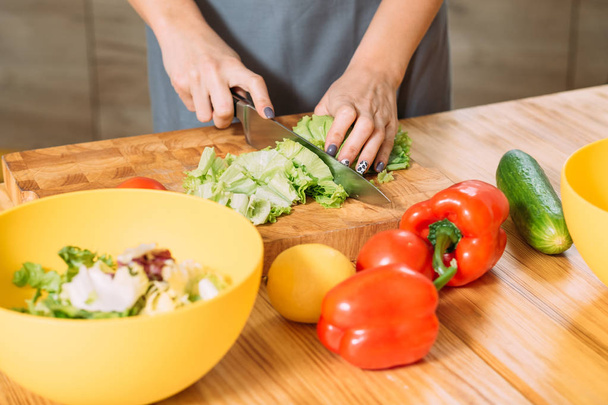 woman hands cutting lettuce healthy balanced salad - 写真・画像