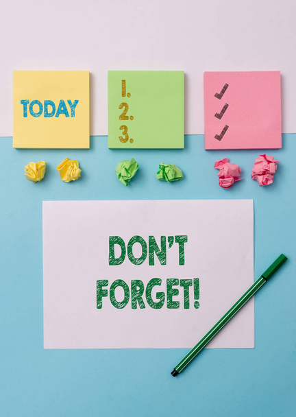 Conceptual hand writing showing Don T Forget. Business photo text used to remind someone about important fact or detail Stationary placed sideways on top of the softhued backdrop. - Photo, Image