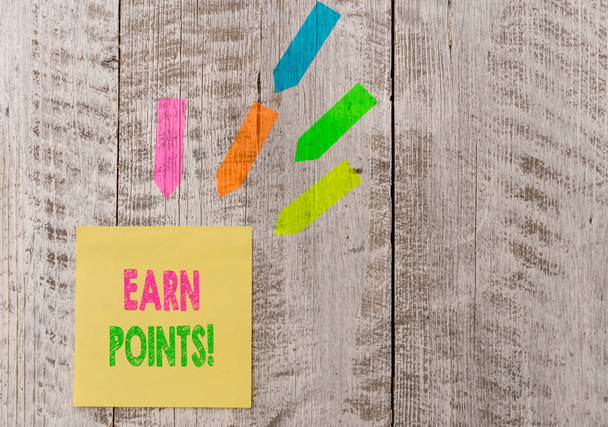 Conceptual hand writing showing Earn Points. Business photo text collecting scores in order qualify to win big prize Note paper and line arrow stickers on the top of wooden table desk. - Photo, Image