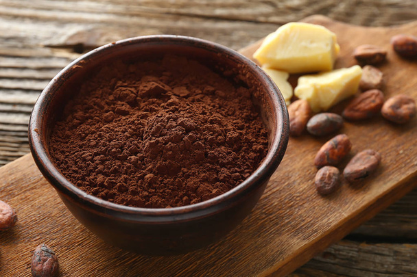 Bowl with cocoa powder on wooden background - Photo, Image