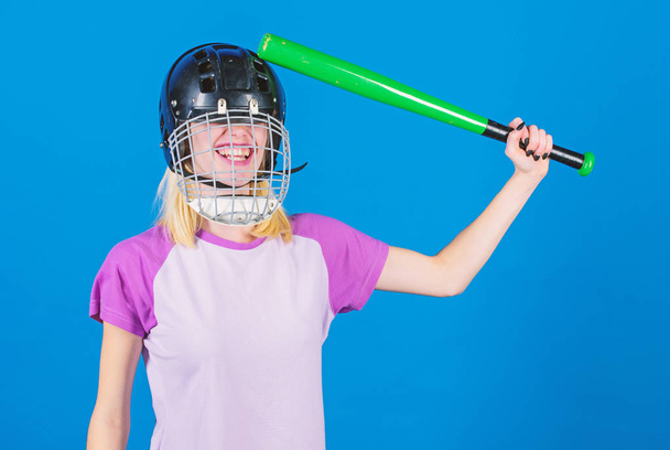 Girl confident pretty blonde wear baseball helmet and hold bat on blue background. Baseball female player concept. Ready repel attack. Woman enjoy play baseball game. Woman in baseball sport - Foto, immagini