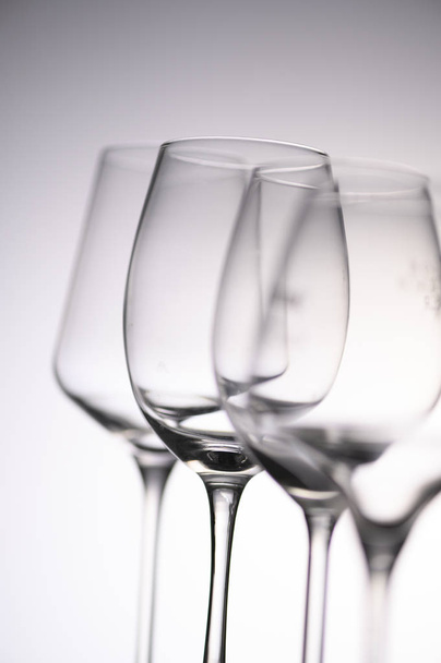 Empty Wine Glasses on white and grey background - Foto, afbeelding