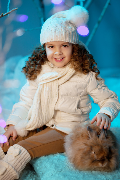 Little winter girl with rabbit - Фото, изображение