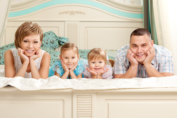 Happy family smiling at home - Фото, зображення