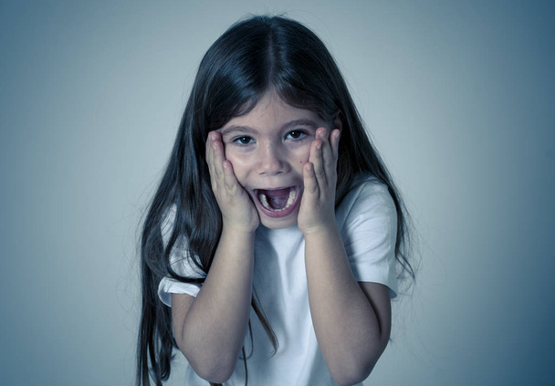 Portrait of Cute happy, excited, funny, cheerful young kid girl with shocked surprised face hearing good and unexpected news. In children and Positive human emotions and expressions. - Foto, Imagen