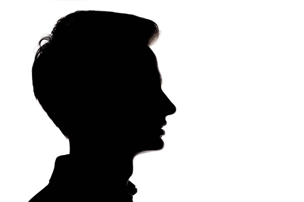 sziluettje fiatalember arc profil egy fehér elszigetelt backgro - Fotó, kép