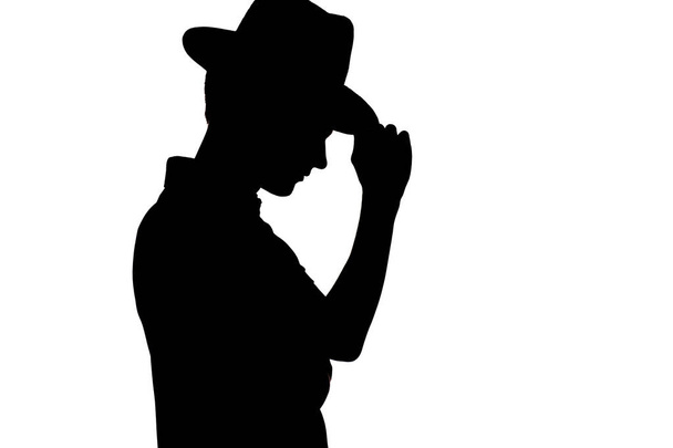 sylwetka stylowego młodego mężczyzny w biznesie kapelusz, profil nierozpoznawalny facet na białym tle tła - Zdjęcie, obraz
