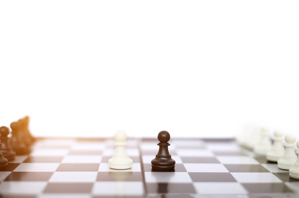 Chess pawns on a chessboard. Isolated on the white background. - 写真・画像