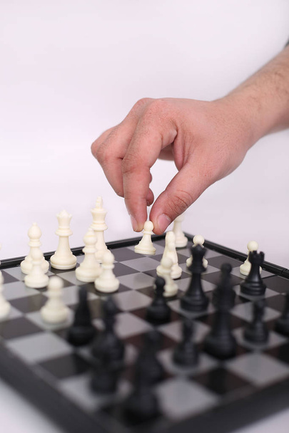 Portrait of man is playing chess. Isolated on the white background. - Foto, Imagem