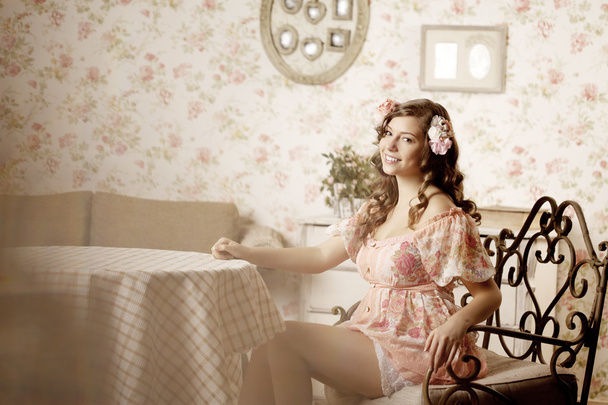 Woman sitting in a room with a vintage interior - Φωτογραφία, εικόνα