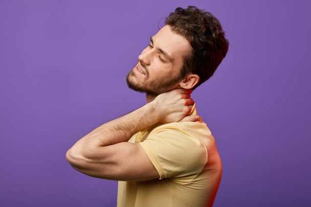 attractive man has pain in neck.how do you relieve spasms in neck  - Foto, Imagem