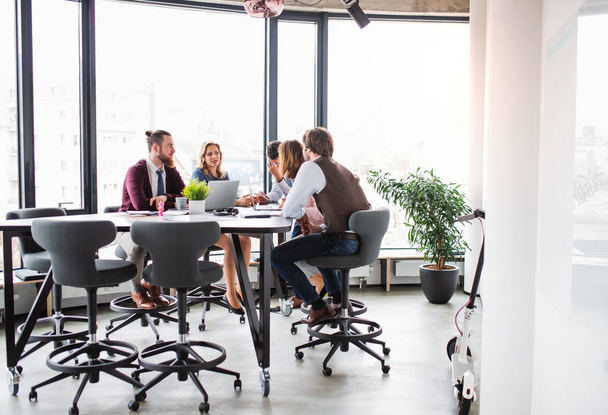 A group of business people sitting in an office, having meeting. - Photo, image