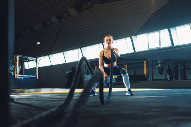 Full length wide angle shot of a young woman working out with ba - Foto, Imagem