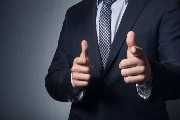  a man business suit points finger. - Фото, изображение