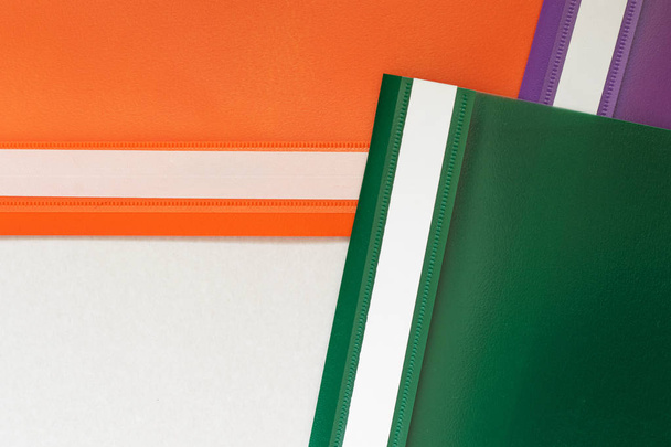 Plastic folders in three colors. - Valokuva, kuva