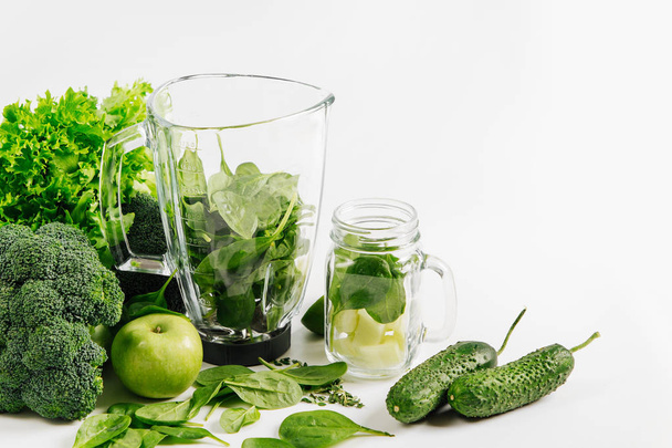 Ingredients for green smoothies in a blender. Healthy food concept with spinach and green vegetables. Vegetarian food. - Fotó, kép