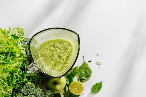 Healthy smoothies in a blender. Healthy food concept with spinach and green vegetables. Vegetarian food. - Photo, Image