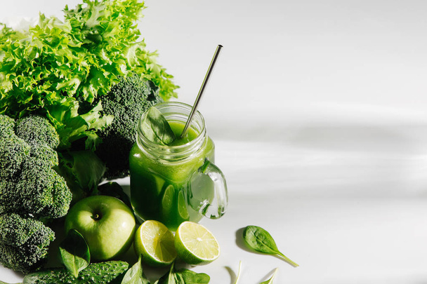 Green healthy smoothie with fruits and vegetables. Detox and diet  concept. Vegetarian food. - Фото, зображення
