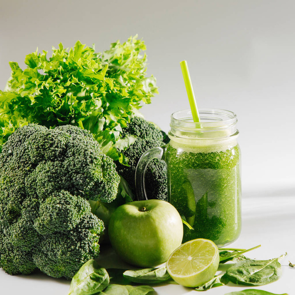Fresh blended green smoothie in  jar on white table. Detox and diet  concept. Vegetarian food. - Fotografie, Obrázek