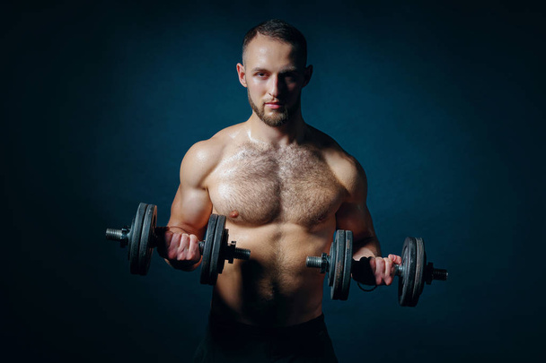 Strong sport sirtless man making weightlifting with dumbbells - Photo, Image