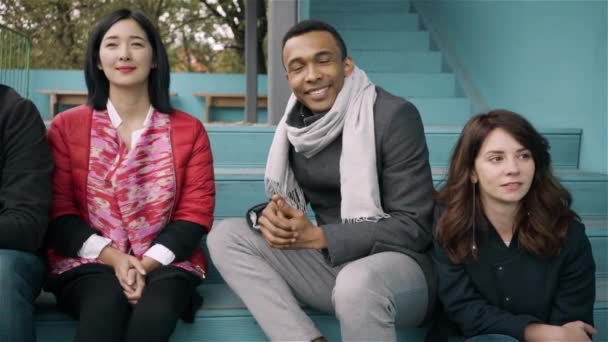 Diverse group of young people smiling and looking at camera - Filmagem, Vídeo