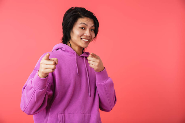 Photo of happy asian guy 20s wearing sweatshirt rejoicing and po - Foto, immagini