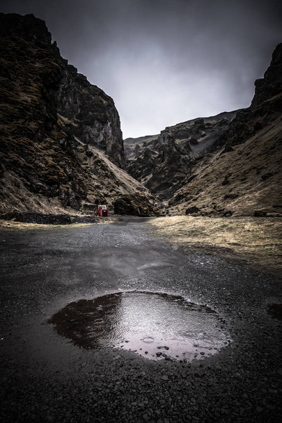 Round puddle and rain on a stony rocky mountain landscape of Ice - Fotoğraf, Görsel