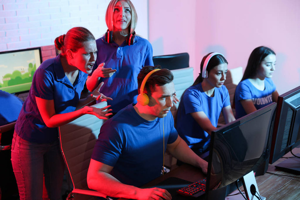 Young people playing video games on computers indoors. Esports tournament - Fotoğraf, Görsel
