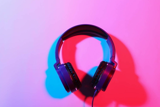 Stylish headphones on color background, top view - Fotó, kép