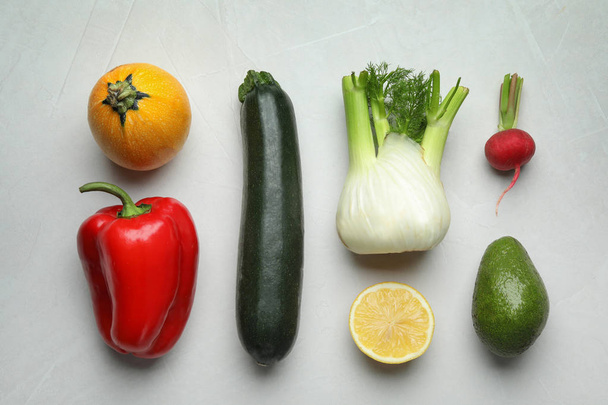 Flat lay composition with fresh ripe vegetables and fruits on light background - Fotó, kép