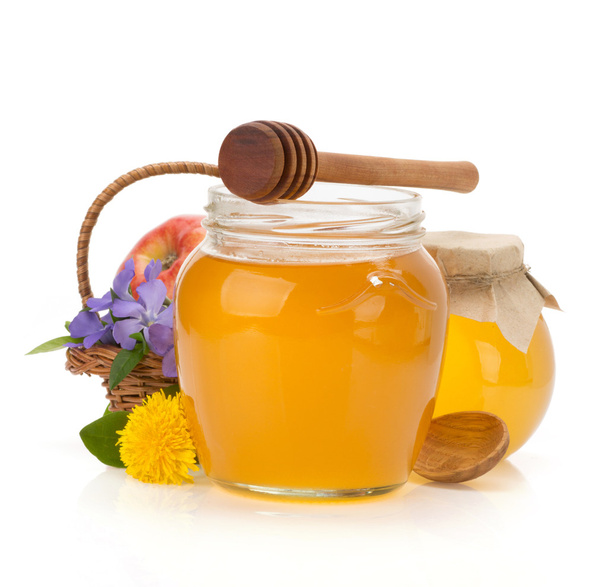 glass jar full of honey and stick - Foto, imagen