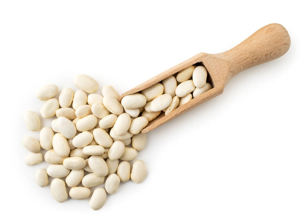 White beans spilled from a wooden spoon. The form of the top. - Foto, imagen