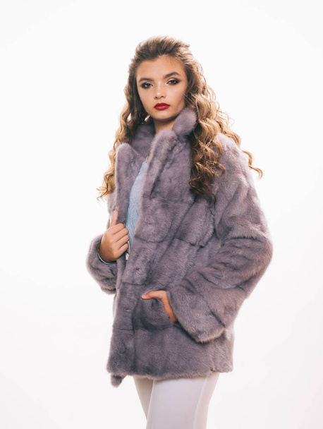 The key piece of her closet. Winter fashion trends. Young woman wear elegant winter coat. Pretty woman in fashionable fur coat. Fashion model wear luxurious fur. Perfect for winter cold - Valokuva, kuva
