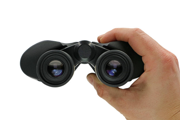 close up, front view of hand holding black binoculars on white background - Photo, Image