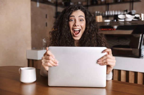 Excited happy woman using laptop computer - 写真・画像
