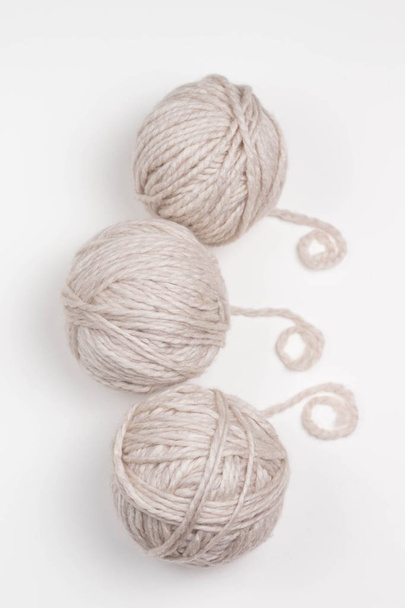 tree beige kniting balls of wool on white background - Fotoğraf, Görsel