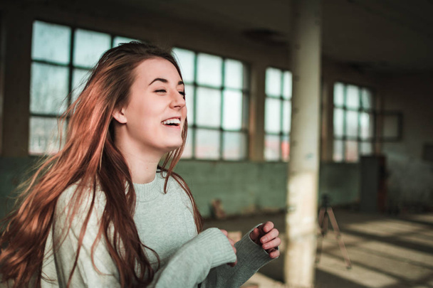 Cute, redhead teenage girl in gray sweater. Human emotions, expressions - Foto, afbeelding