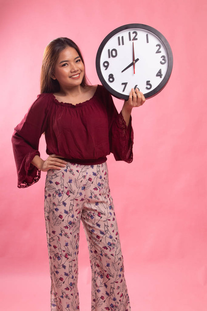 Young Asian woman with a clock. - Photo, Image