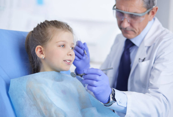 Little girl sitting in the dentists office - Photo, Image