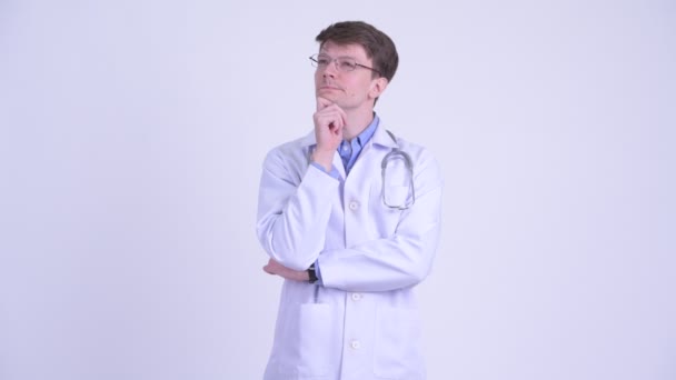 Happy young handsome man doctor thinking - Video