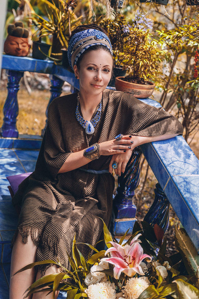 Close up portrait of young woman wearing gem stone jewellery - Valokuva, kuva