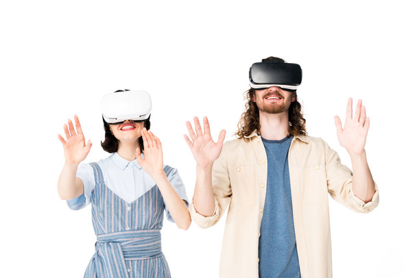 young man and girl with VR headset raising hands in air isolated on white - Foto, imagen
