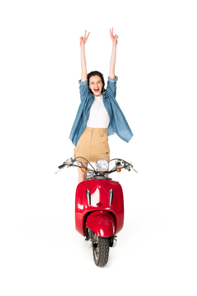 full length view of girl standing on red scooter and showing peace sign isoalted on white - Zdjęcie, obraz