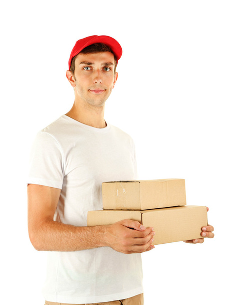 Young delivery man holding parcels, isolated on white - Fotografie, Obrázek