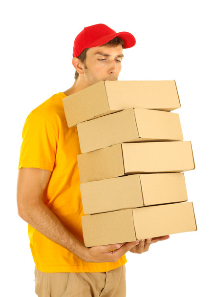 Young delivery man holding parcels, isolated on white - Foto, imagen