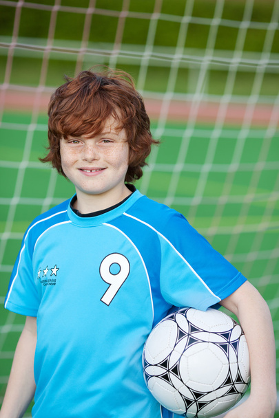 Boy Holding Soccer Ball Against Net - Φωτογραφία, εικόνα