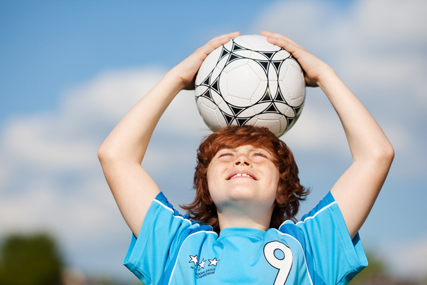 Boy Holding Soccer Ball On Head Against Sky - Fotoğraf, Görsel