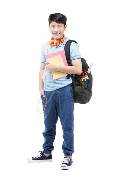 Smiling little student boy in blue polo t-shirt in with books an - Foto, imagen