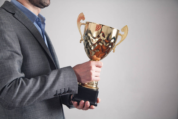 Businessman holding golden trophy. Business, Success - Foto, immagini