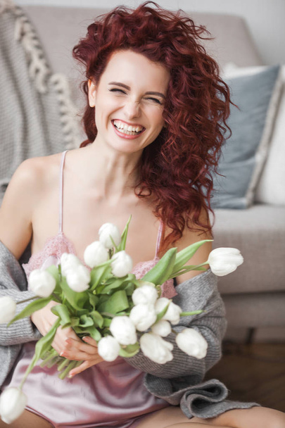 Very attractive young woman indoors. Portrait of curly haired female. Redhaired beautiful woman at home. - Foto, Bild
